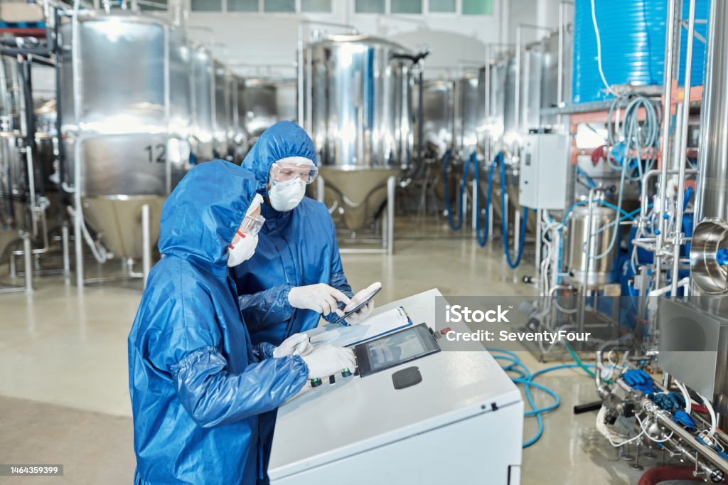 Operating Tools And Controls Two Workers Operating Equipment At Factory And Using Control Panel ...