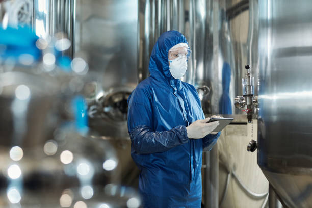 istock Worker wearing protective suit at industrial factory 1464359722