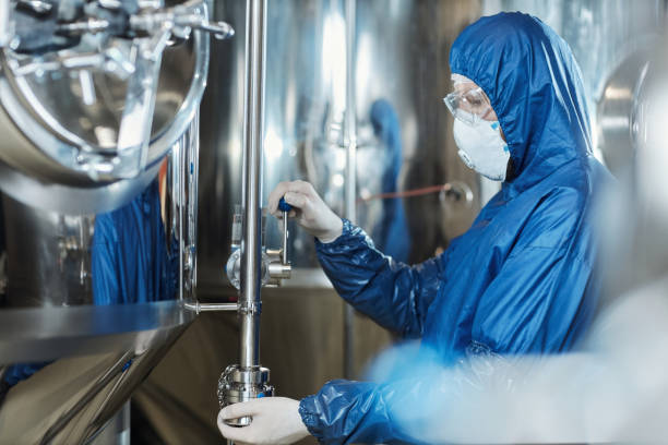 istock Man wearing protective gear working at chemical factory workshop 1464360080
