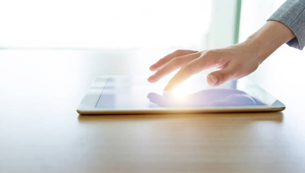 istock Businesswoman hand pointing to digital tablet 1464364376
