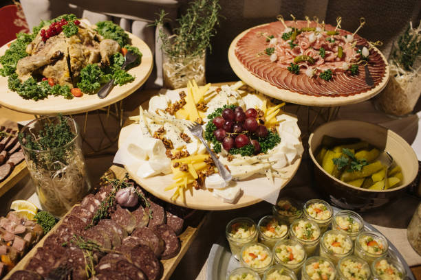 istock Catering table background. Wedding decorative ham slices. Cheese snack. Cheese tray. Various meat snacks background. Salami slice, sausage piece. 1464364475
