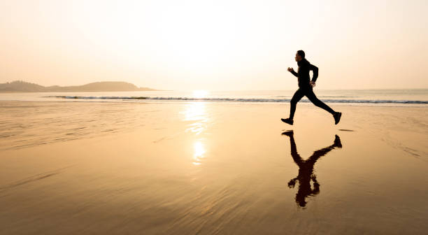 istock Man running on the golden beach 1464364727