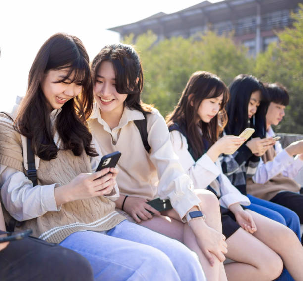 istock Happy young group using the mobile phones at school 1464364941