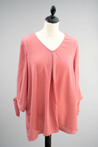 istock A beautiful rose pink top hangs on a headless mannequin. 1464365201