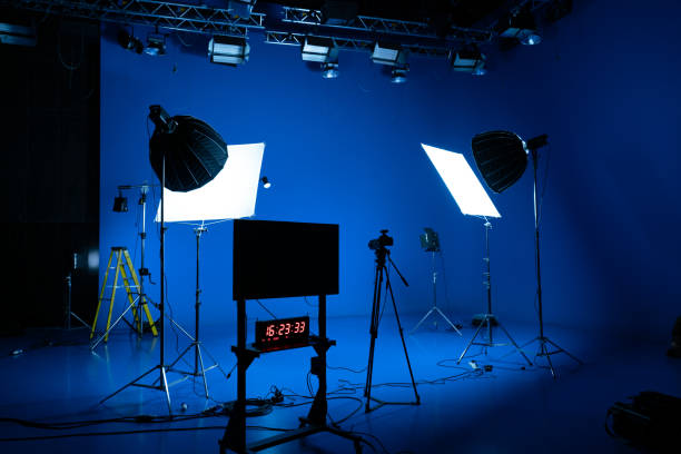 istock Professional video studio behind-the-scenes video footage behind-the-scenes silhouette production photography with a focus on camera and studio equipment. 1464366539