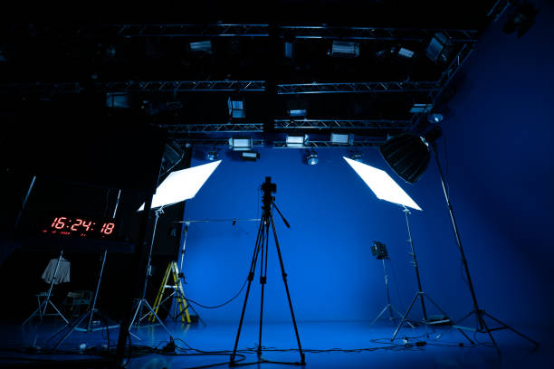 istock Professional video studio behind-the-scenes video footage behind-the-scenes silhouette production photography with a focus on camera and studio equipment. 1464366542