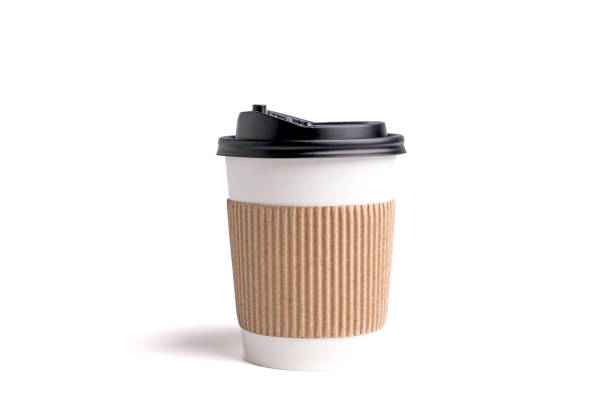 istock paper coffee mugs for disposable use on a white background, and coffee beans in the foreground 1464366573