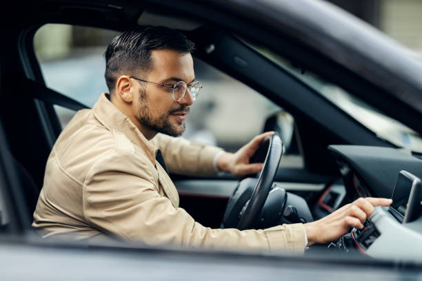 istock A smart casual commuter is adjusting gps while sitting in a car and preparing for business trip. 1464367298