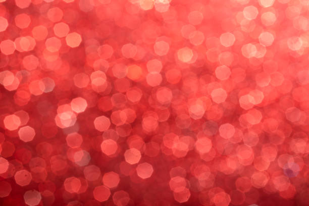 Defocused sequin light. Studio shooting of a creative bright red color background. It is textured color gradient. There are no text and no people, and have copy space for design. Its Suitable for commercial use. Christmas, New Year, Diwali festive celebrations themed backgrounds, wallpapers, templates for greeting cards, banners and posters and wrapping paper is apt.