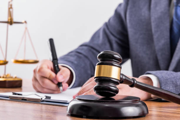 istock Man before the scales and judge hammer 1464371362