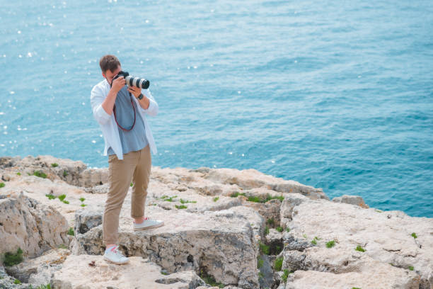 istock man with professional dslr camera taking picture of seashore 1464371614