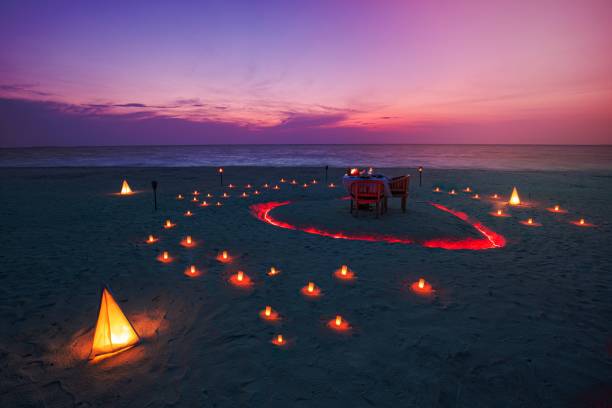 istock Beautiful table set up for a romantic meal on the beach 1464372552