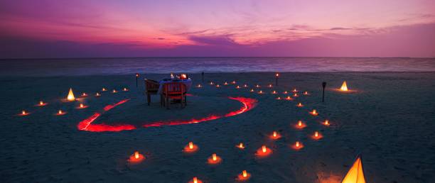 istock Beautiful table set up for a romantic meal on the beach 1464376644