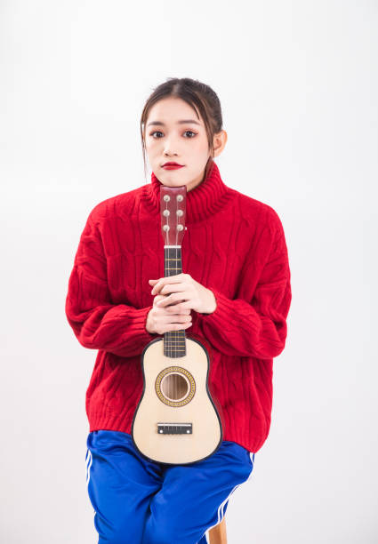 The guitar is made of beautiful wood. The ukulele. isolated. close-up.