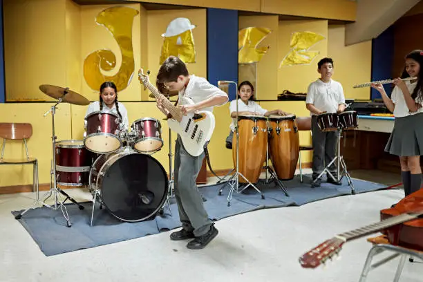 Photo of Elementary students playing instruments in music room