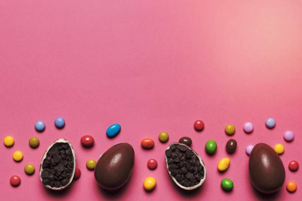 istock gem candies chocolate easter eggs filled with choco chips pink background. High quality beautiful photo concept 1464383382