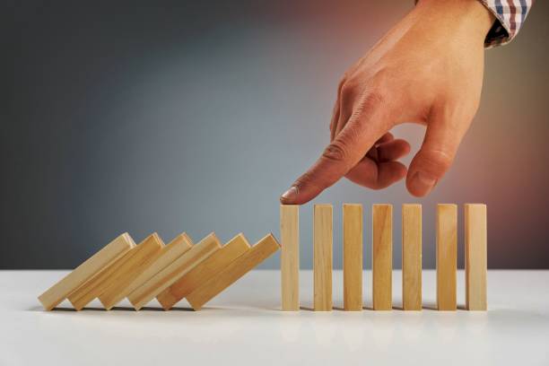 istock wooden blocks paused from falling 1464384058