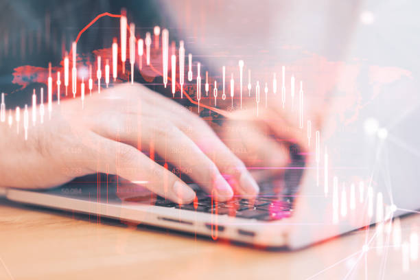istock Close up of hands using laptop computer with glowing falling red forex chart on blurry background. Stock exchange and crisis concept. Double exposure. 1464384122