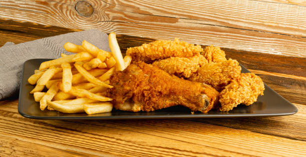 istock Breaded Fried Chicken Wings, Fingers and Drumsticks on Wooden Rustic Background Side View 1464387829