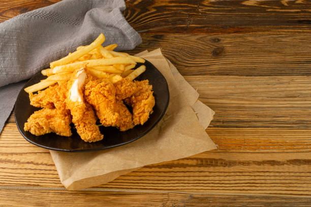 istock Breaded Fried Chicken Wings, Fingers and Drumsticks on Wooden Rustic Background Side View 1464387838