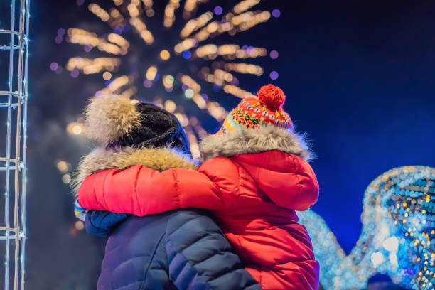 happy family looking fireworks in the evening sky. fireworks new year, christmas. Crazy 2020 is over, it's 2021 stock photo