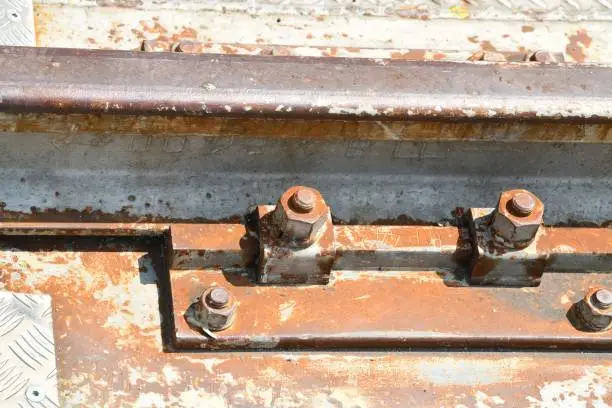 A Close-up of a fishplate, a rusty metal connecting plate with bolts