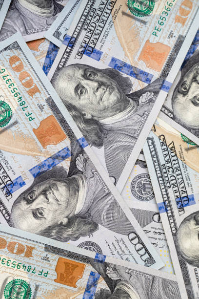 istock vertical background of one hundred dollar bills 1464394712