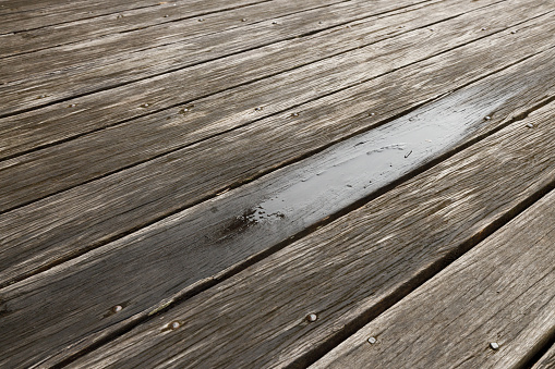 Looking along part of a wet timber deck.