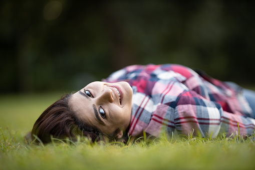 Young woman lying in park