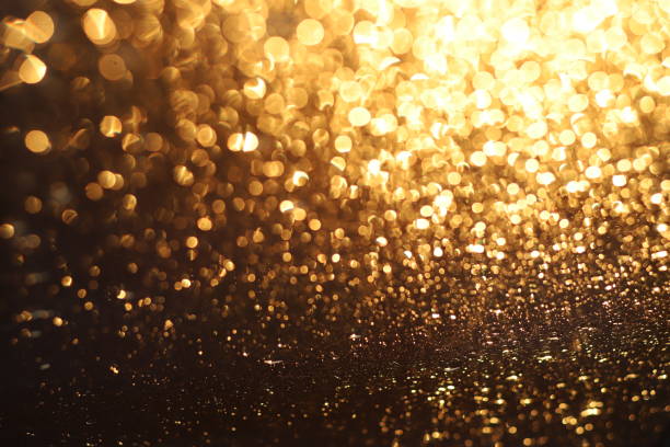 istock Golden shiny glitter lights from water drops 1464397299