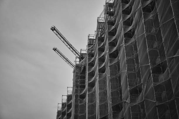 istock Grayscale of a safety net on an apartment building during construction 1464397620