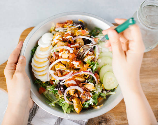 istock Holding a bowl of fresh salad with cucumbers 1464397816