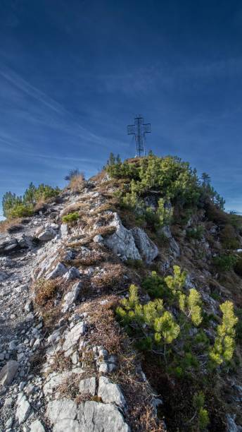 istock Path leading to a mountain peak with its iconic Metall cross 1464399693