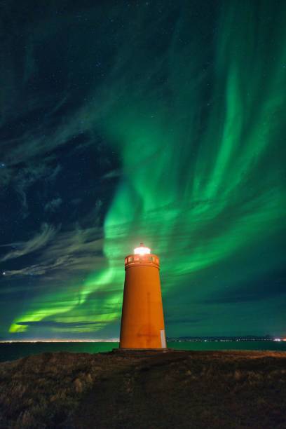 istock Northern lights aurora borealis over lighthouse in Iceland 1464401530