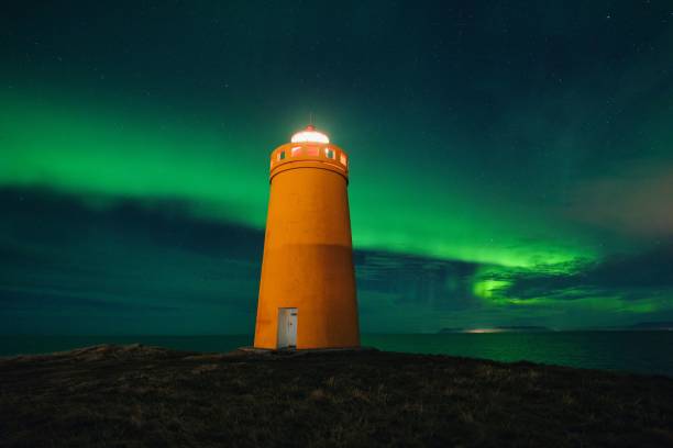 istock Northern lights aurora borealis over lighthouse in Iceland 1464401531
