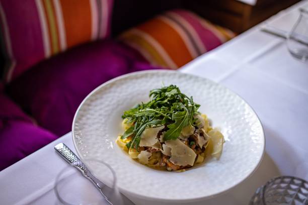 istock White plate with pasta with rucola at a restaurant 1464402112