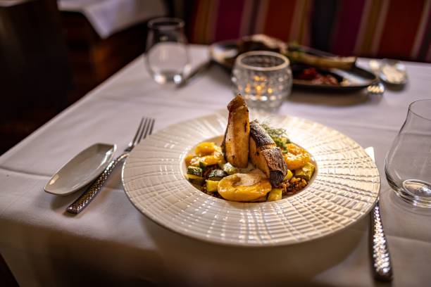 istock White plate with fish and potatoes at a restaurant 1464402114