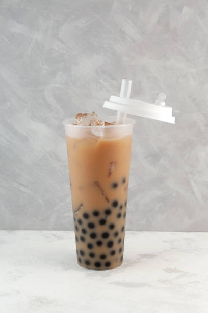 istock Boba drink or Bubble milk tea in tall plastic cup. Bubble milk tea. Disposable plastic take away cup 1464402485