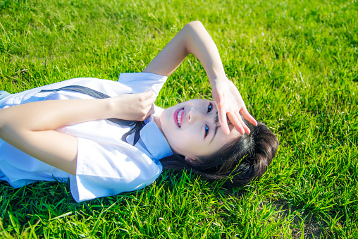 The girl lying on the grass