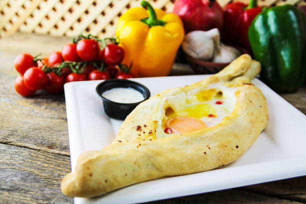 istock Delicious Adjarian khachapuri with egg on a white plate 1464405325