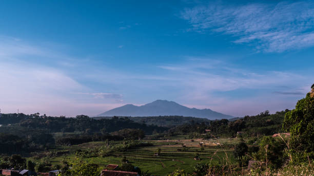 istock Beautiful landscape surrounded by mountains gleaming under the cloudy blue sky 1464406186