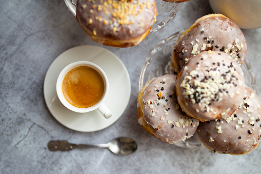 A top view of Polish Paczki donuts with a cup of coffee