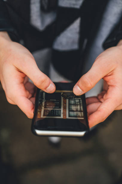 istock Man holding a smartphone with the blurred background 1464407542