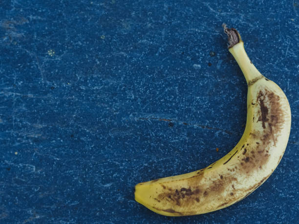 istock Top view of an old banana on a blue background 1464408070