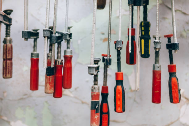 istock Bunch of manual limes hanging in carpenter workshop 1464409536
