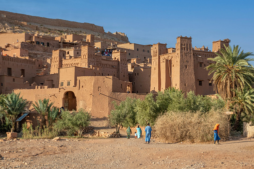 The Ksar of Aït-Ben-Haddou - a group of mud-brick houses surrounded by high walls - is a good example of a traditional living environment in the Pre-Saharan region south of the Atlas Mountains. The houses are close together within defensive walls reinforced by corner towers. Some houses are modest, others resemble small urban castles with tall corner towers and the upper parts decorated with motifs in brick. Located in Ouarzazate province, Aït-Ben-Haddou gives a good idea of earthen building techniques in pre-Saharan Africa. The oldest structures appear to be no earlier than the 17th century, although their structure and technique were used earlier in the valleys of southern Morocco.