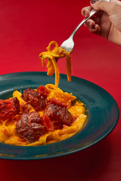 istock Pasta with meatballs on a red background 1464411684