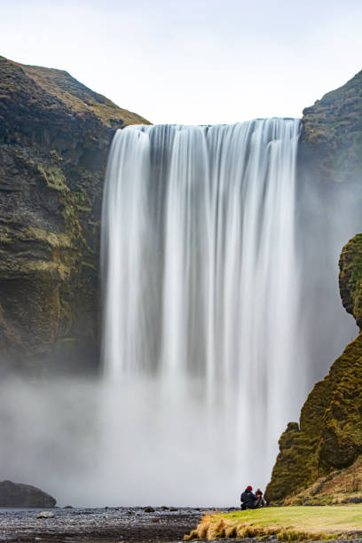 istock Mesmerizing view of a waterfall between green hills in Skogafoss, Iceland 1464411770