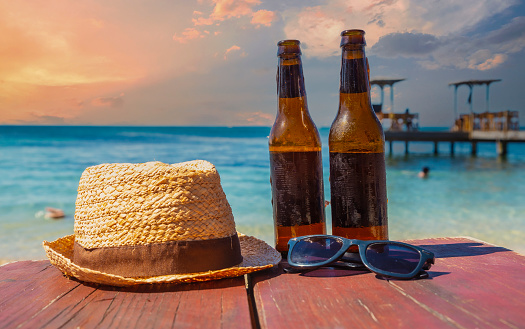 Two Beers Hat And Sunglasses On A Wooden Surface On West End Beach On ...