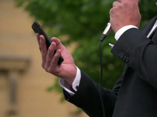 Photo of Politician reading speech from cellphone